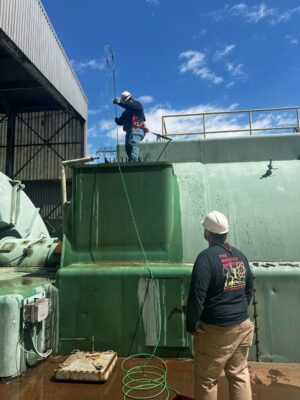 The Merrick Group employee cleaning power plant equipment to extend plant equipment lifespan