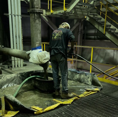 The Merrick Group employee performing heat exchanger cleaning services as part of a proactive power plant maintenance plan.