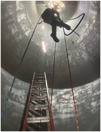 Professional tank cleaning specialists carrying out industrial tank cleaning services.